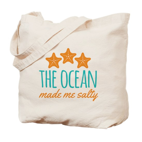 Custom printed tote bag with design featuring starfish illustrations and text that reads: The Ocean Made Me Salty