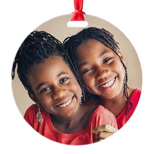 round, circle ornament with custom printed photo showing two sisters hugging