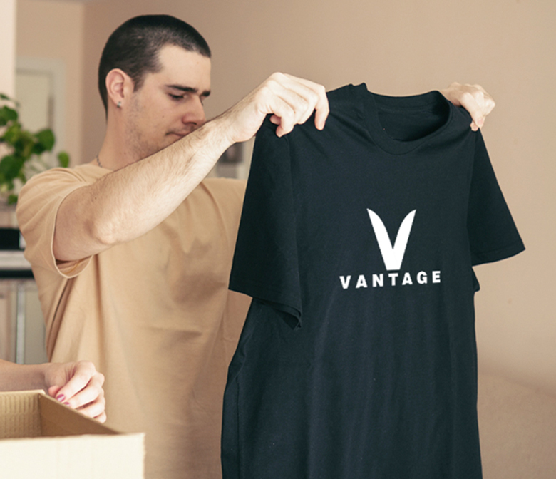 Woman hanging decorted t-shirt on wall