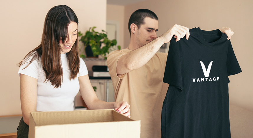 Woman hanging decorted t-shirt on wall