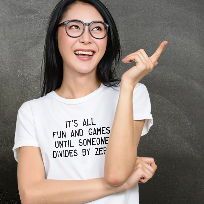 Teacher smiling while wearing a CafePress designed shirt with a funny design that reads: It's all fun and games until someone divides by zero.