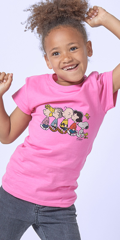 Smiling African American young girl dancing in her new officially licensed Peanuts CafePress shirt.