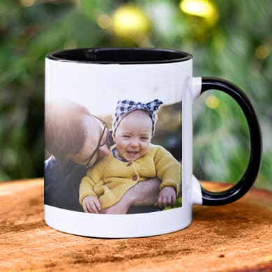 Coffee mug in a Christmas setting with a custom photo of a family.