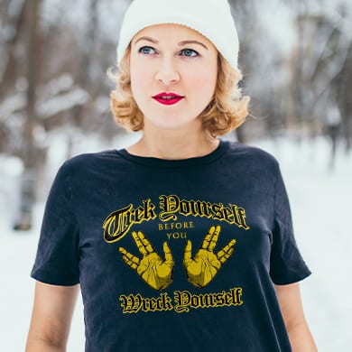 Woman wearing a t-shirt with an official licensed Star Trek design showing illustrated hands making the Vulcan salute and stylized text that reads: Trek Yourself Before You Wreck Yourself.