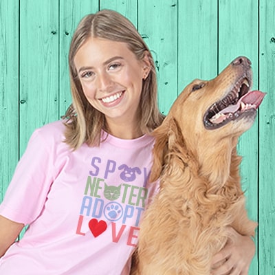 Young woman and her dog. The woman is wearing a pink custom printed t-shirt that reads: Spay Neuter, Adopt, Love.