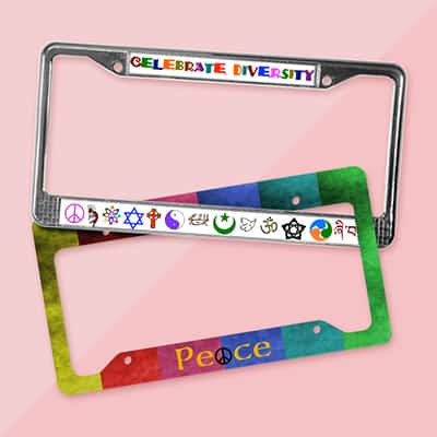 2 car license plate frames stacked on top of one another. One reads - Celebrate Diversity. The other reads - Peace.