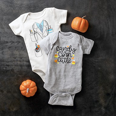 Two Halloween themed baby bodysuits with custom designs. One design makes the bodysuit look like a doctor costume. The second design shows illustrations of candy corn with stylized text that reads: candy corn cutie.