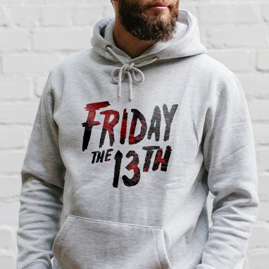 Man wearing a white Halloween hoodie with a custom printed official licensed Friday the 13th movie text design.