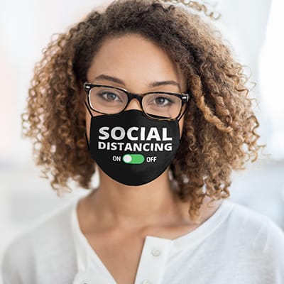 Female wearing a mask with a design that reads - Social Distancing - then has an on/off switch underneath the words.