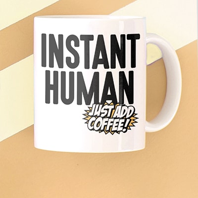 Custom printed coffee mug with funny stylized text design that reads: Instant Human. Just Add Coffee.