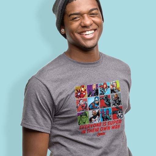 Male laughing and wearing an officially licensed (C)MARVEL t-shirt design showcasing all the super heroes.