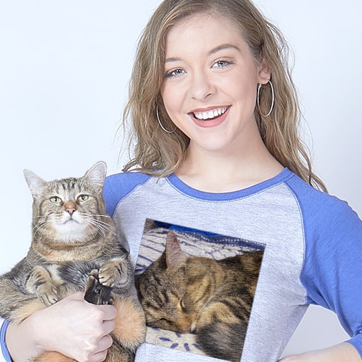 Woman holding a cat and wearing a personalized baseball t-shirt with the cats photo printed on it.