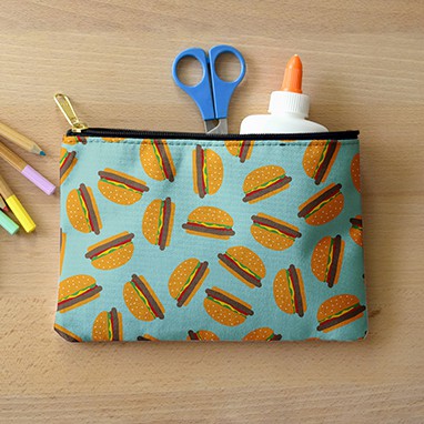 Zipper pouch holding school items with custom cute hamburger pattern design.