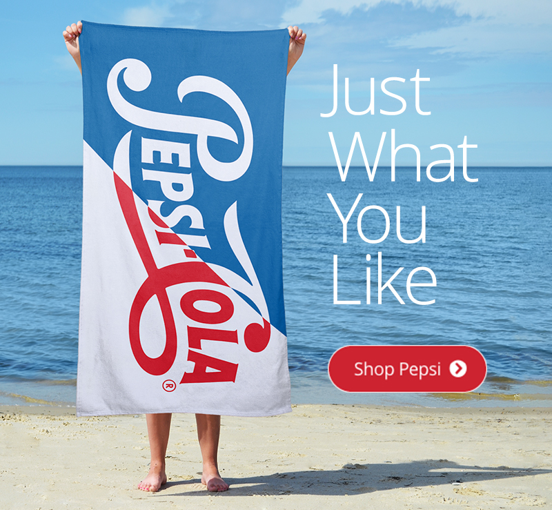 Someone standing on a beach holding up an officially licensed Pepsi Cola design.