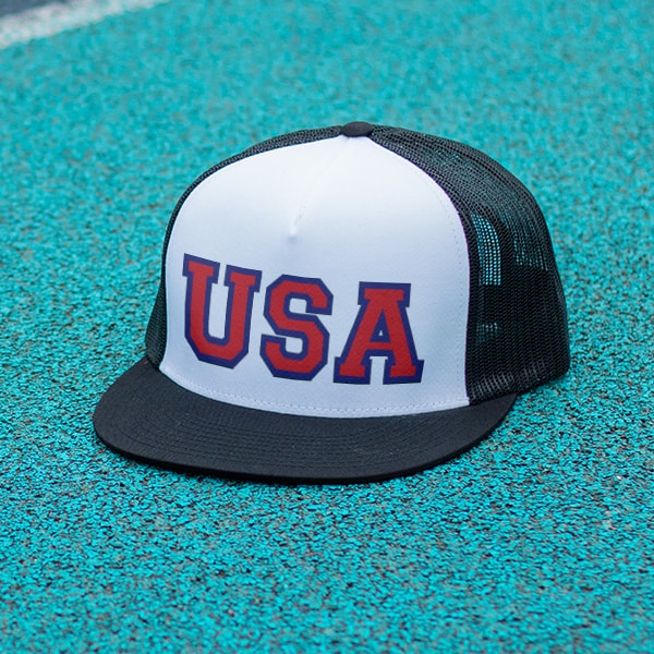 A black and white hat sitting on a track with a USA design printed on it.