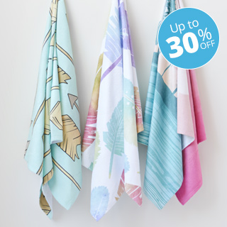 3 beach towles hanging on hooks