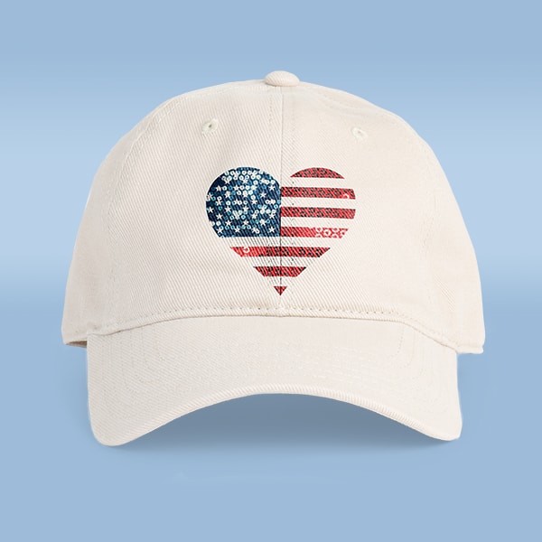 A white hat with a rustic heart shaped design of the American Flag.