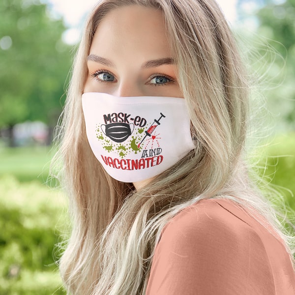 Female wearing a custom mask with a coronavirus design that reads - Masked and Vaccinated.