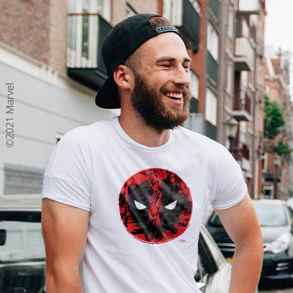 Man on street in white t-shirt with official licensed Marvel Deadpool logo design.