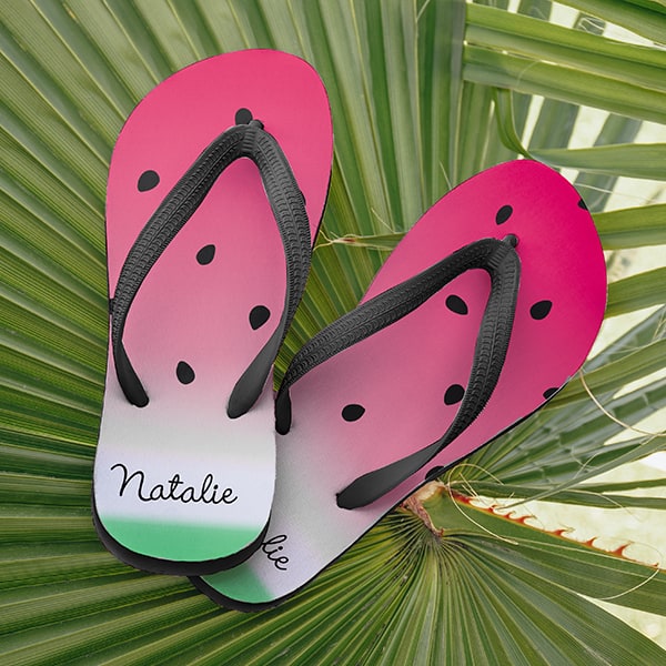 A pair of flip flops printed to look like a watermelon and customized with your name near the heel.