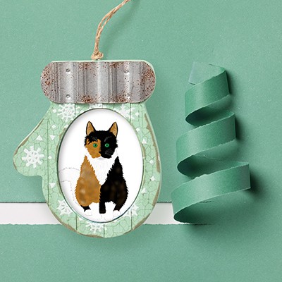 Custom mitten shapped ornament with a picture of a calico cat illustration on a light green background.