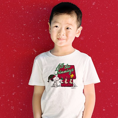A young boy wearing a Snoopy holiday t-shirt.