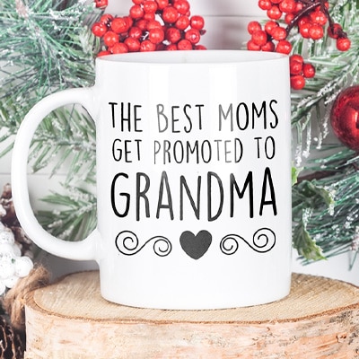Coffee mug with custom design featuring stylized text that reads: The Best Moms Get Promoted to Grandma.