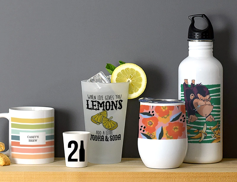 Multiple items from CafePress' extensive line of custom drinkware sitting on a wooden shelf displaying various designs found on site.