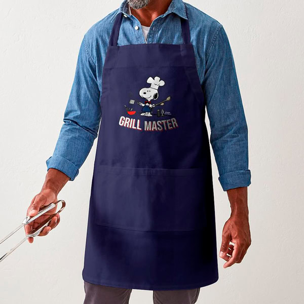 Man wearing an apron with Snoopy and text that says: Grill Master.