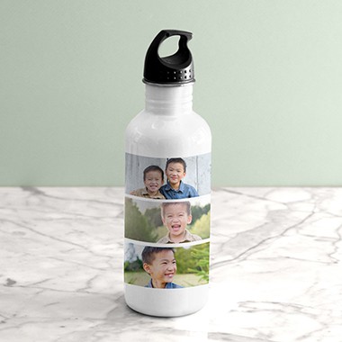 A water bottle sitting on a marbled countertop with a custom photo collage of two young boys.
