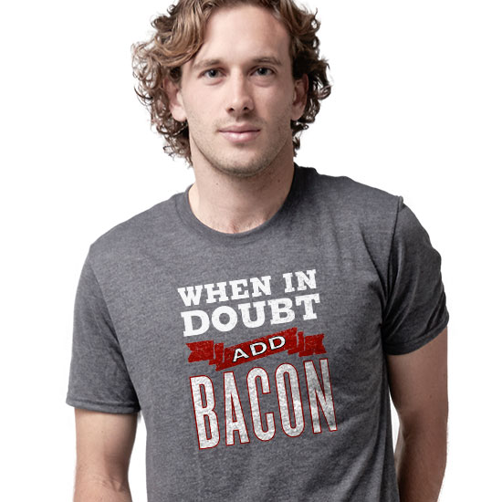 Gift Ideas for Pet Lovers. Image of a man and his bulldog. The dog is licking his face. The man is wearing a custom printed classic tee with a design that reads: Best Dog Dad Ever.