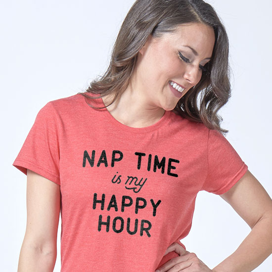 Gift Ideas for Book Lovers and Writers. Image of woman sitting on a bed with coffee and a good book. The coffee mug has a design custom printed on it that reads: Drink Coffee, Read Boos, Be Happy.